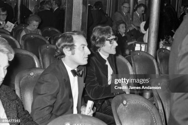 French fashion designer Yves Saint Laurent and his partner Pierre Bergé attend the 'Revue of 1968' at the Folies Bergères theatre in Paris, 9th...