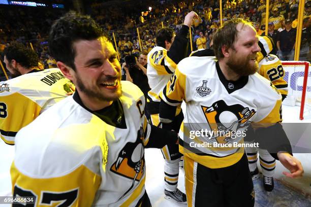 Sidney Crosby of the Pittsburgh Penguins celebrates with Phil Kessel after defeating the Nashville Predators 2-0 in Game Six of the 2017 NHL Stanley...