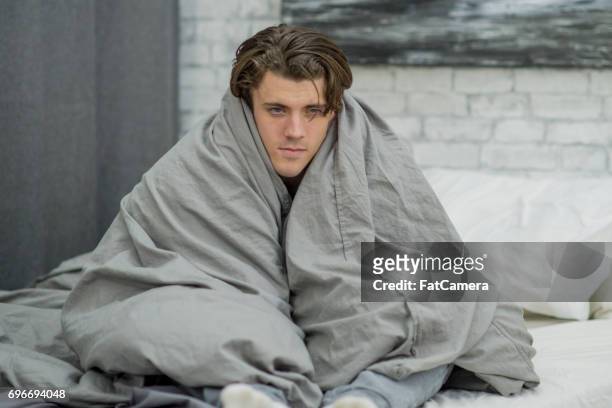 huddled in blankets - fever chills stock pictures, royalty-free photos & images