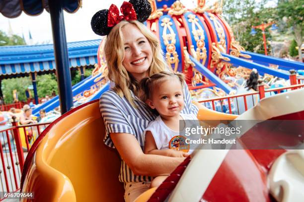 In this handout image provided by Disney, Actress Candice Accola shares a special moment with her daughter, Florence May, after taking flight on...