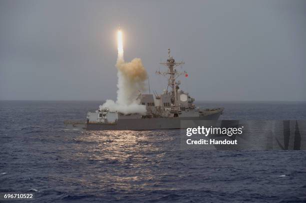 In this handout photo provided by the U.S. Navy, the guided-missile destroyer USS Fitzgerald launches a missile from the aft missile deck during...