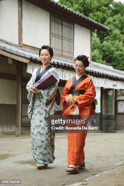 beautiful japanese women wearing kimono walking in old village, edo period - track town classic 2016 stock pictures, royalty-free photos & images