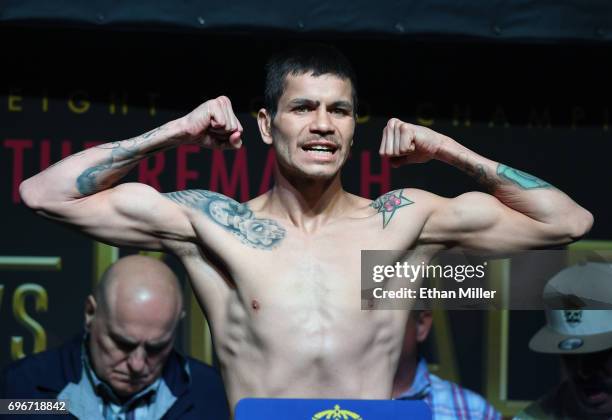Boxer Moises Flores poses on the scale during his official weigh-in at the Mandalay Bay Events Center on June 16, 2017 in Las Vegas, Nevada. Flores...