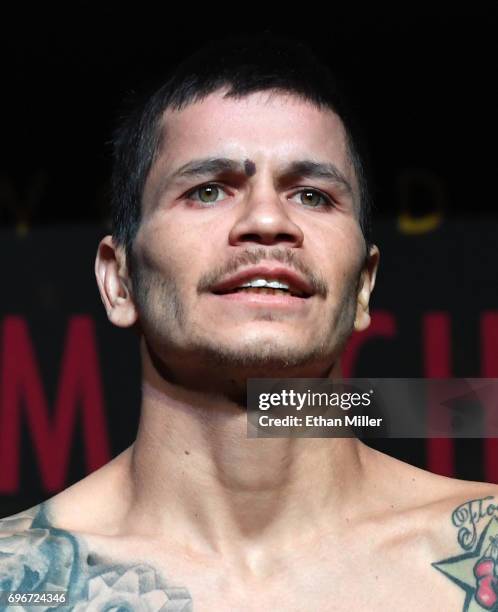 Boxer Moises Flores poses on the scale during his official weigh-in at the Mandalay Bay Events Center on June 16, 2017 in Las Vegas, Nevada. Flores...