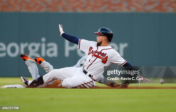 Ender Inciarte of the Atlanta Braves doubles as he slides safely into second base past Dee Gordon of the Miami Marlins in the first inning at...