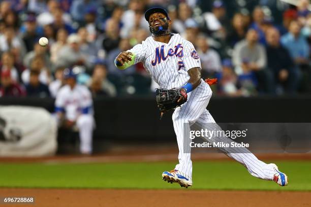 Jose Reyes of the New York Mets is unable to throw out Ryan Raburn of the Washington Nationals for an infield single in the fifth inning at Citi...