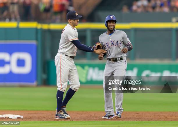 Houston Astros shortstop Carlos Correa nudges away after successfully tagging him during the MLB game between the Texas Rangers and Houston Astros on...