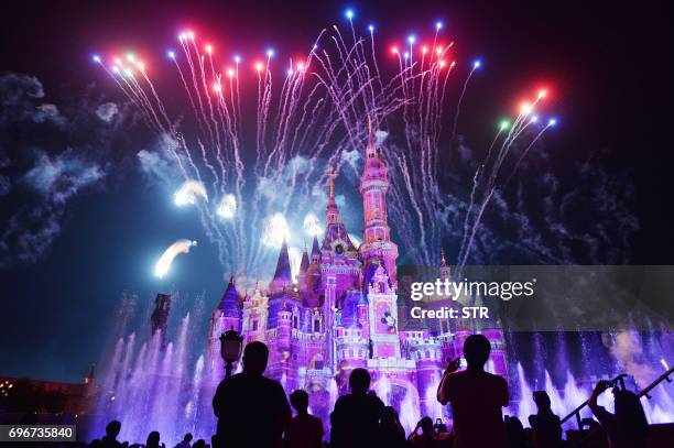 This photo taken on June 16, 2017 shows visitors watching fireworks exploding over the castle at an event to mark the first anniversary of the...
