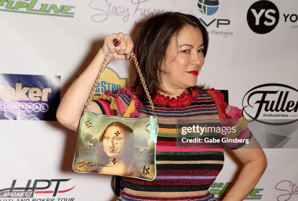 Actress Jennifer Tilly shows off her purse during the Raising the Stakes Celebrity Charity Poker Tournament benefiting the One Step Closer Foundation...