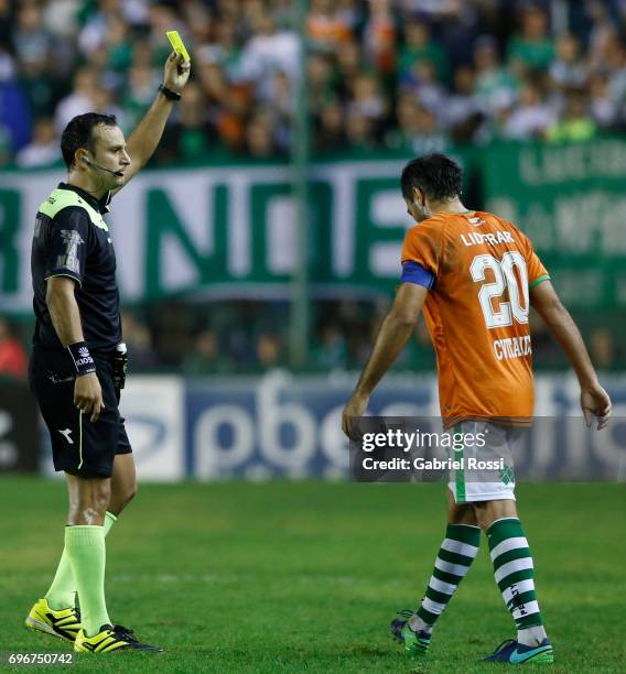 Referee Dario Herrera shows a yellow card to Dario Cvitanich of Banfield during a match between Banfield and Rosario Central as part of Torneo...