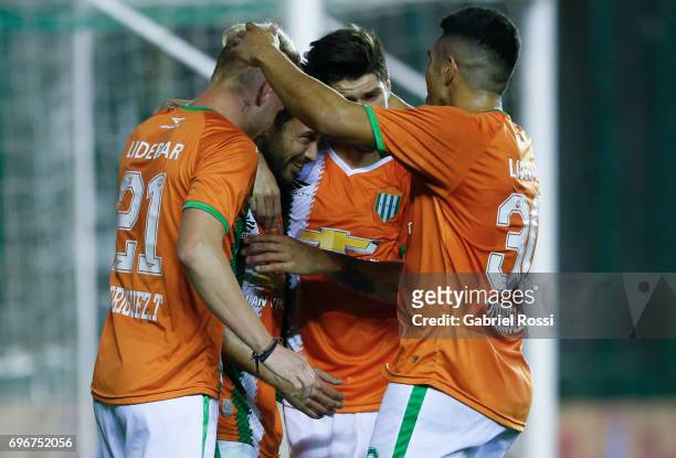 Dario Cvitanich of Banfield celebrates with teammates after scoring the third goal of his team during a match between Banfield and Rosario Central as...