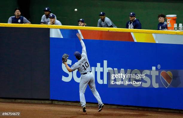 Hunter Renfroe of the San Diego Padres is unable to play the ball off the wall on a double hit by Eric Thames of the Milwaukee Brewers during the...