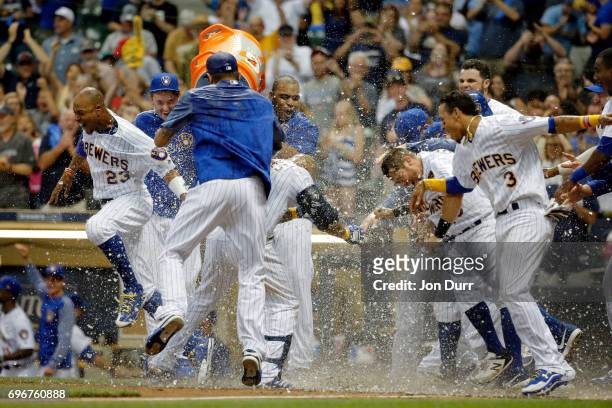 Eric Thames of the Milwaukee Brewers is dunked after hitting a walkoff home run against the San Diego Padres during the tenth inning at Miller Park...