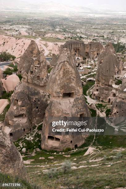 underground living caves and fairy chimneys rock at uçhisar, nevşehir province, central anatolia region, turkey - butte rocky outcrop stock pictures, royalty-free photos & images