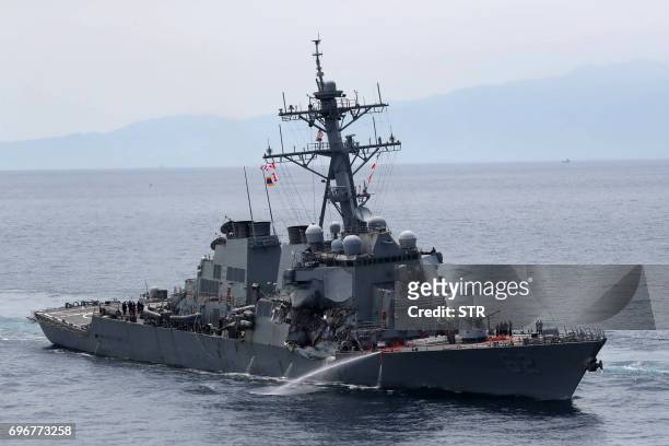 This picture shows the guided missile destroyer USS Fitzgerald off the Shimoda coast after it collided with a Philippine-flagged container ship on...