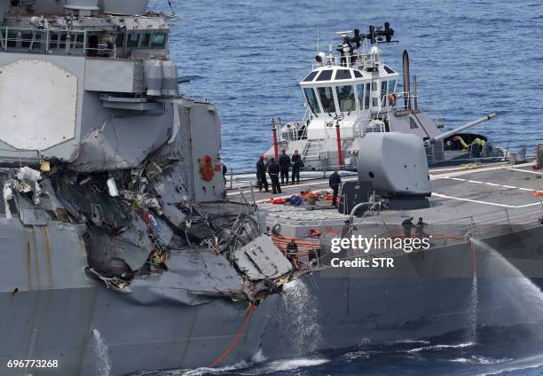 This picture shows damages on the guided missile destroyer USS Fitzgerald off the Shimoda coast after it collided with a Philippine-flagged container...