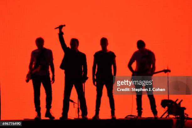 The Edge, Larry Mullen Jr., Bono and Adam Clayton of U2 perform on stage at Papa John's Cardinal Stadium on June 16, 2017 in Louisville, Kentucky.