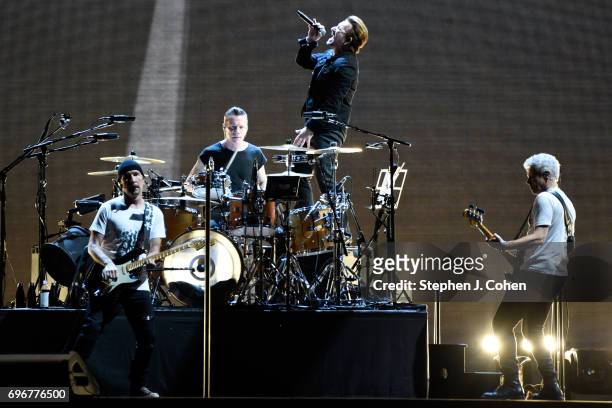 The Edge, Larry Mullen Jr., Bono and Adam Clayton of U2 perform on stage at Papa John's Cardinal Stadium on June 16, 2017 in Louisville, Kentucky.