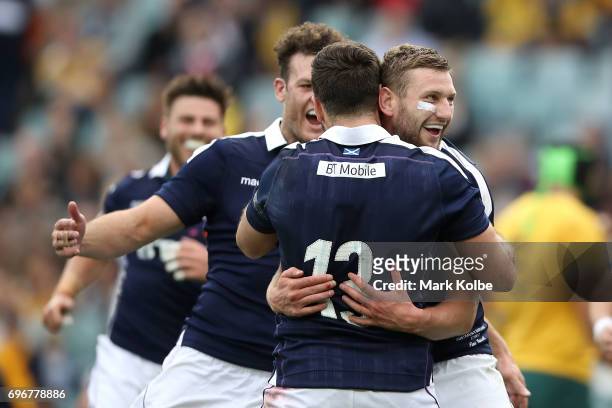 Finn Russell of Scotland celebrates with his team mate Alex Dunbar of Scotland after scoring a try during the International Test match between the...