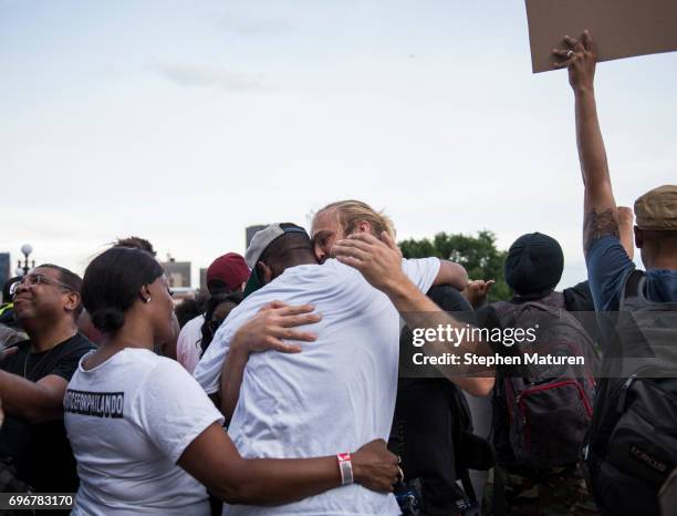 John Thompson, a friend and former colleague of Philando Castile, is embraced after speaking on the steps of the Minnesota State Capitol building on...