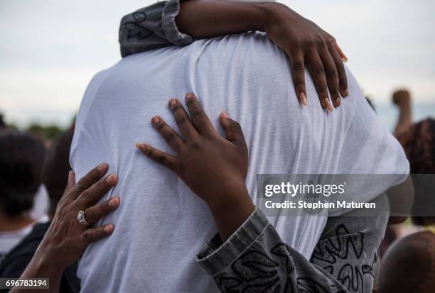 John Thompson, a friend and former colleague of Philando Castile, is embraced after speaking on the steps of the Minnesota State Capitol building on...