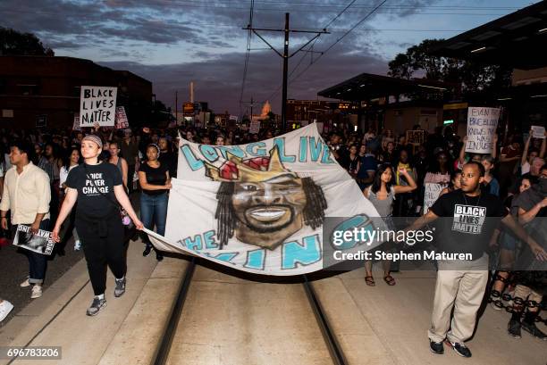 Protestors carry a banner depicting Philando Castile on June 16, 2017 in St Paul, Minnesota. Protests erupted in Minnesota after Officer Jeronimo...