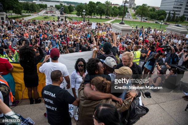 John Thompson, a friend and former colleague of Philando Castile, is embraced after speaking on the steps of the Minnesota State Capitol building on...