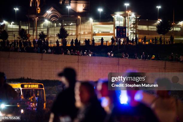People line up to look on as protestors and police face each other on highway 94 on June 16, 2017 in St Paul, Minnesota. Protests erupted in...