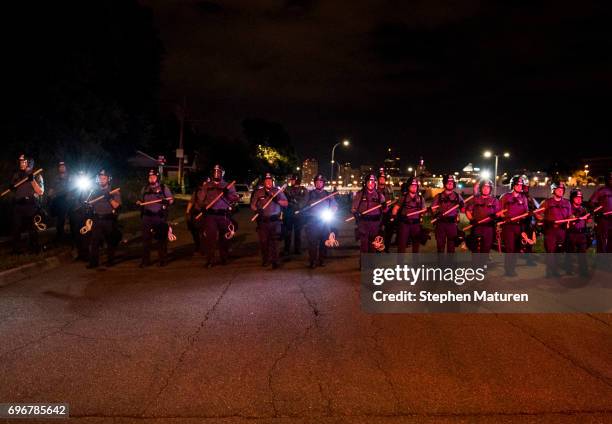 Police officers push protestors back on June 16, 2017 in St Paul, Minnesota. Protests erupted in Minnesota after Officer Jeronimo Yanez was acquitted...