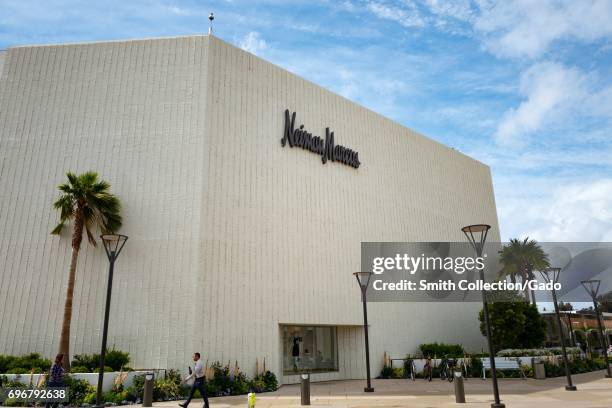 Man walks past the Neiman Marcus department store on a sunny day at the Stanford Shopping Center, an upscale outdoor shopping mall in the Silicon...