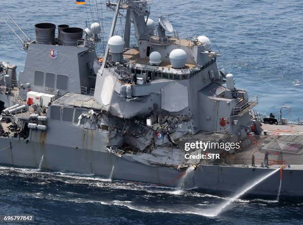 Damage is seen on the guided missile destroyer USS Fitzgerald off the Shimoda coast, after it collided with a Philippine-flagged container ship, on...