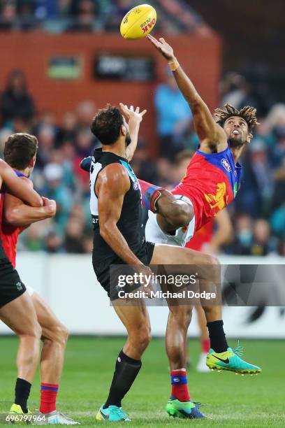 Archie Smith of the Lions taps the ball away from Patrick Ryder of the Power during the round 13 AFL match between the Port Adelaide Power and the...