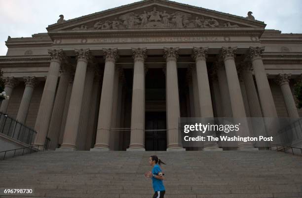 Jogger runs past the National Archives building in Washington, DC. With the government shutdown, the District has become a ghost town.