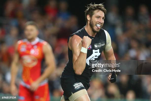 Dale Thomas of the Blues celebrates a goal during the round 13 AFL match between the Gold Coast Suns and the Carlton Blues at Metricon Stadium on...