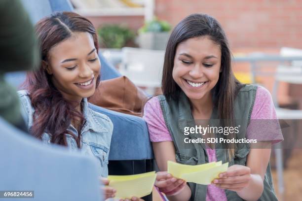 female college students study with note cards - flash card stock pictures, royalty-free photos & images