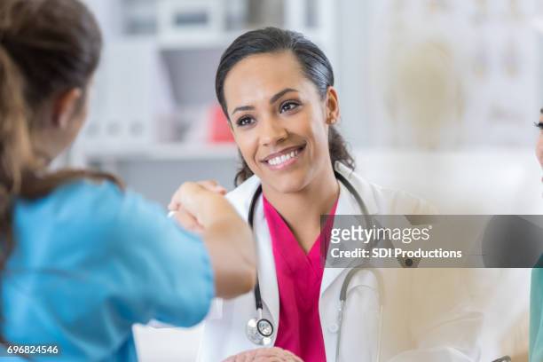confident female doctor interviews potential nurse - happy candidate stock pictures, royalty-free photos & images