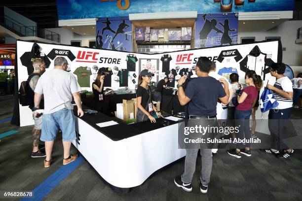 Fans shop for merchandise during the UFC Fan Experience at Singapore  News Photo - Getty Images