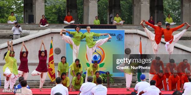 Participants perform an advanced Yoga sequence during an event to mark the International Yoga Day at the Independence Square, Colombo, Sri Lanka on...