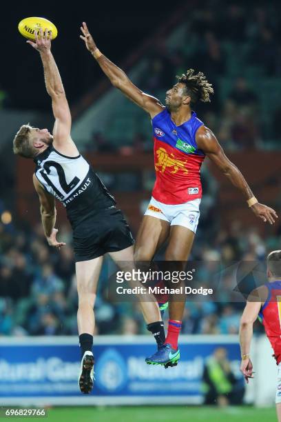 Archie Smith of the Lions and Jackson Trengove of the Power compete for the ball during the round 13 AFL match between the Port Adelaide Power and...