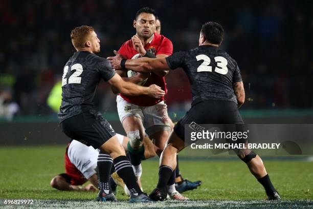 Ben Te'o of the British and Irish Lions is tackled by New Zealand Maori All Blacks' Ihaia West and Rob Thompson during the international rugby match...