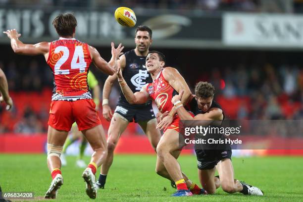 Jesse Lonergan of the Suns is tackled during the round 13 AFL match between the Gold Coast Suns and the Carlton Blues at Metricon Stadium on June 17,...