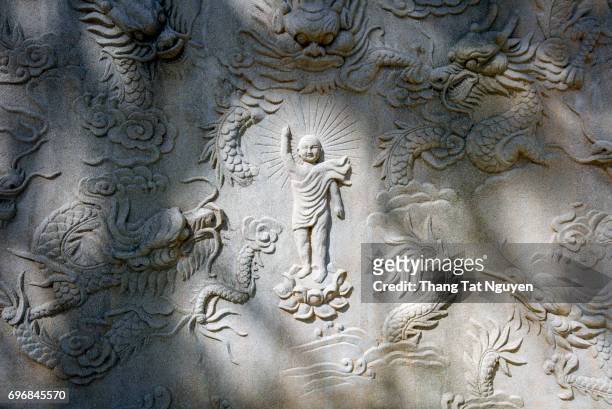sculpture of buddha and dragon  in wall in chinese pagoda in dalat, viennam - world heritage mahabodhi stock pictures, royalty-free photos & images