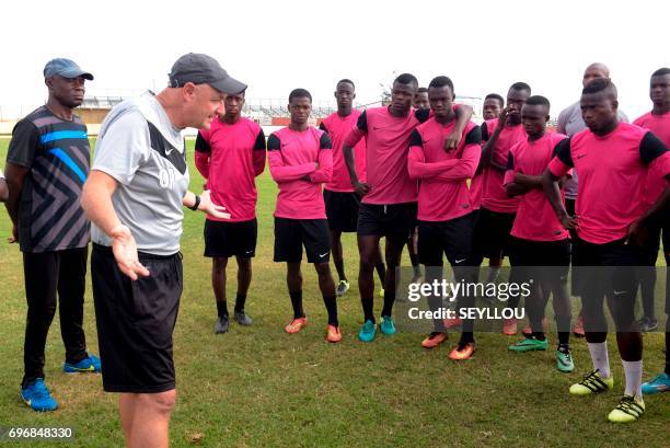French coach Olivier Perrin speaks to players during a training session at the Generation Foot Academie on June 14, 2017 in Deni Biram Ndao, eastern...