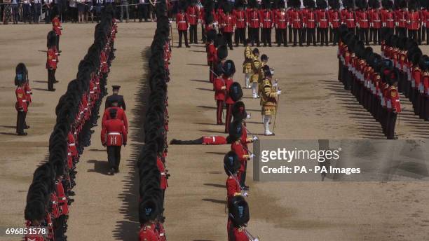 Guardsman lies prone after fainting during the Trooping the Colour ceremony at Horse Guards Parade, central London, as the Queen celebrates her...
