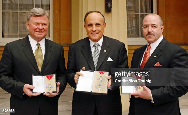 Former New York Mayor Rudolph Giuliani with his Knighthood of the British Empire medal, New York Fire Department Commissioner Thomas Van Essen and...