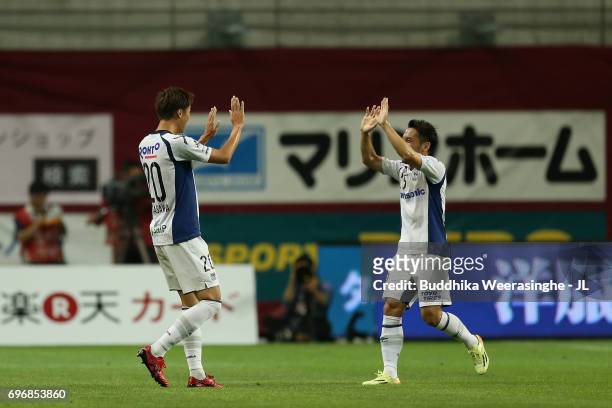 Shun Nagasawa of Gamba Osaka celebrates scoring the opening goal with his team mate Jungo Fujimoto during the J.League J1 match between Vissel Kobe...