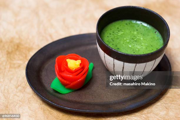 camellia-shaped wagashi and matcha green tea - japanese sweet stock-fotos und bilder