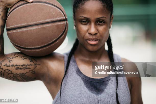 müde, junge frau mit dem ball - womens basketball stock-fotos und bilder