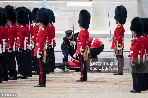 Guardsman lies on a stretcher after fainting during the annual Trooping The Colour parade in Horse Guards Parade on June 17, 2017 in London, England....