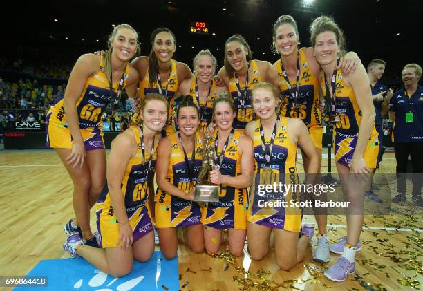 The Lightning pose for a team photo with the Suncorp Super Netball trophy after winning the Super Netball Grand Final match between the Lightning and...